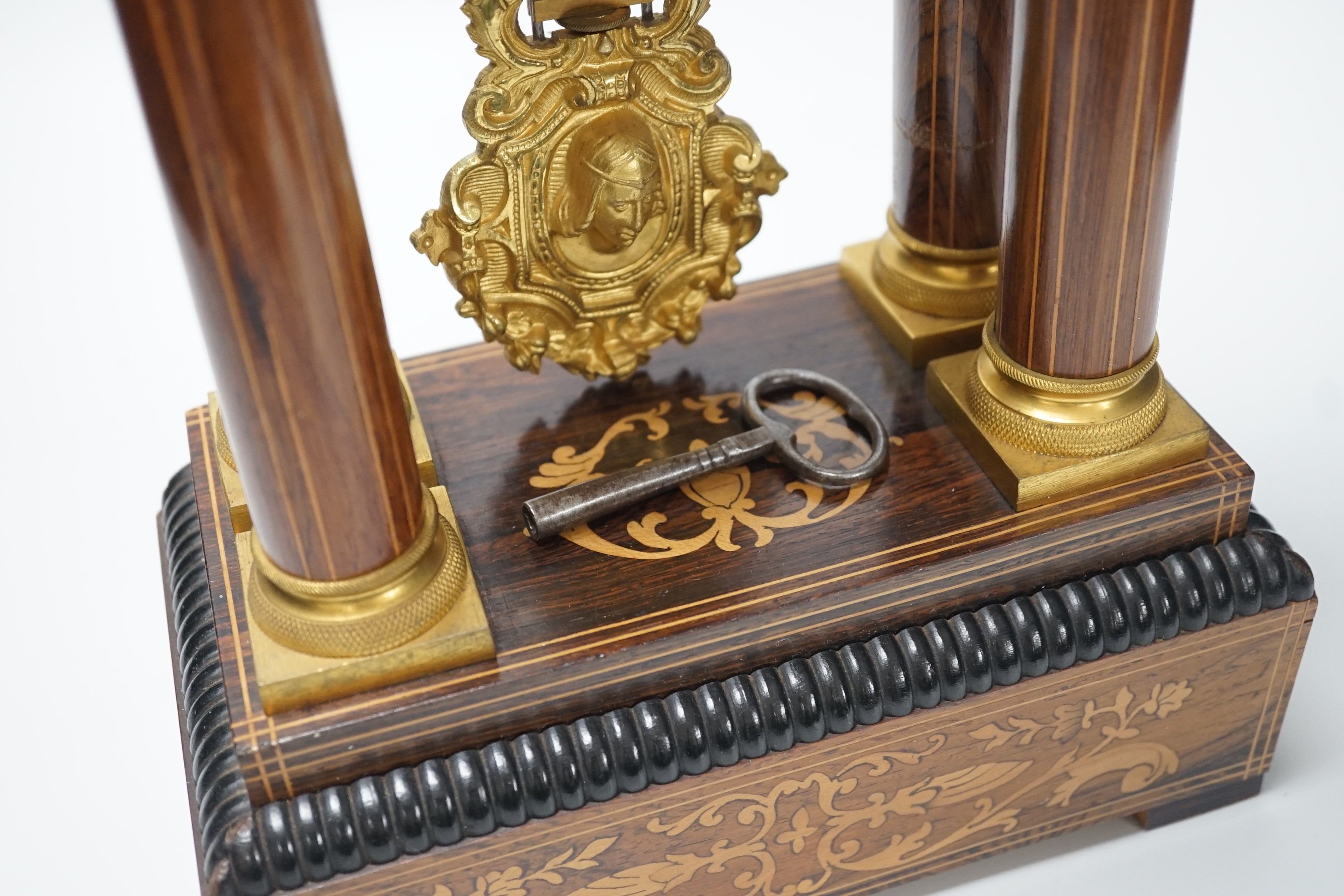 A late 19th century rosewood and marquetry portico clock with ormolu mounts